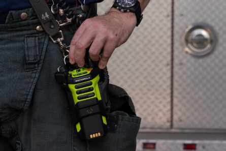Officer holding Motorola radio