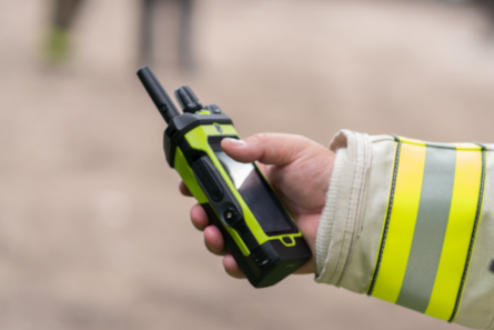 Police officer in the field using radio with SmartProgramming update software